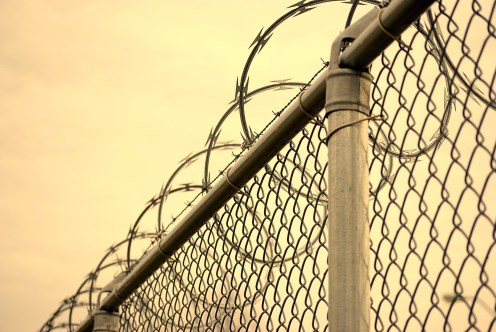 Chain link fence with razor wire on top